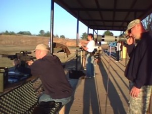03-17-09_1846 An Army sharpshooter (far right) instructs Hall while watching tracers from the M4 variant.