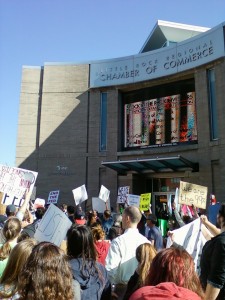 Protesters stop in front of the Little Rock Chamber of Commerce. Organizers told the group that the movement would need the support of the chamber. (Photo by Sitton)