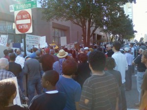 The crowd stops in front of the Stephens Building, which houses Little Rock's branch of the Federal Reserve. (Photo by Sitton)