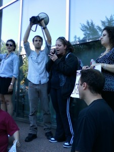 Adam Lansky holds the bullhorn while Andrea Ross reads the Occupy Wall Street manifesto to protesters.