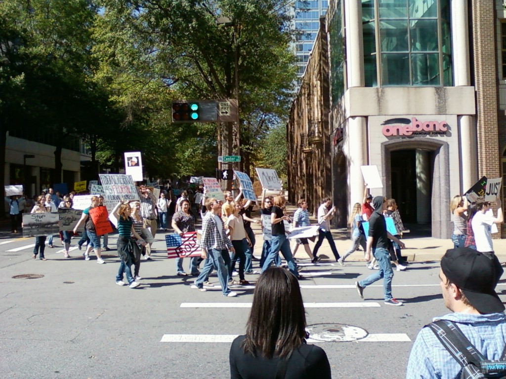 Protesters return along the same route down Center Street towards the River Market. (photo by Sitton)